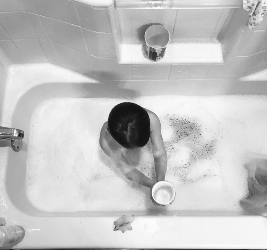 child taking a bath